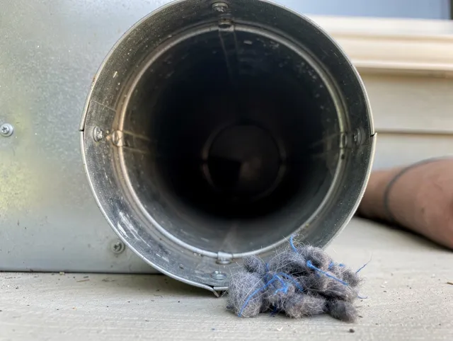 Streetsboro Dryer Vent Cleaning technician using specialized equipment to clear severe dryer vent blockage in Streetsboro